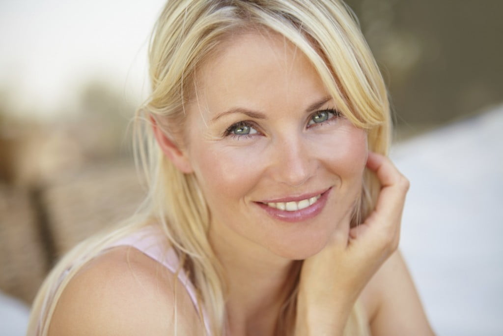 Mature woman smiling with raised brow