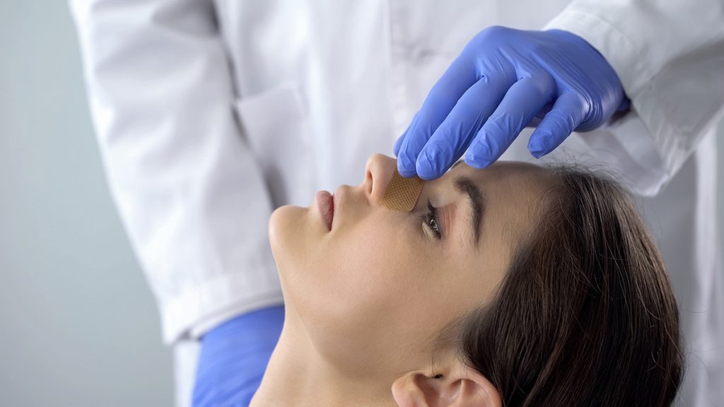 Woman during a rhinoplasty consultation with a plastic surgeon