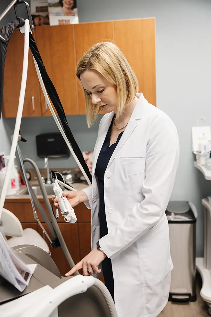 Female Plastic Surgeon in Boston, Dr. Alannah Phelan, standing in operating room