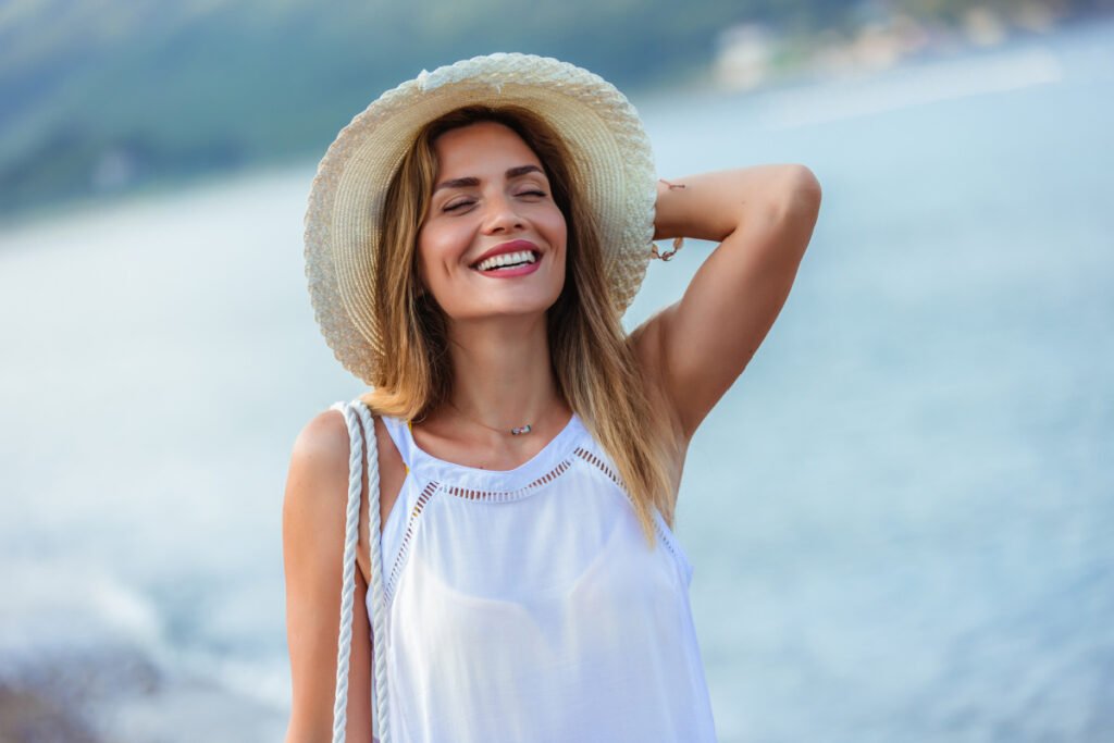 Woman smiling while walking outside during early summer