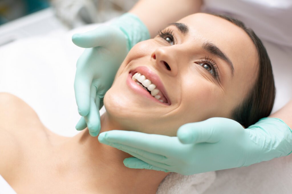 Woman smiling during skin care consultation with aesthetician for non-surgical skin treatments at a med spa