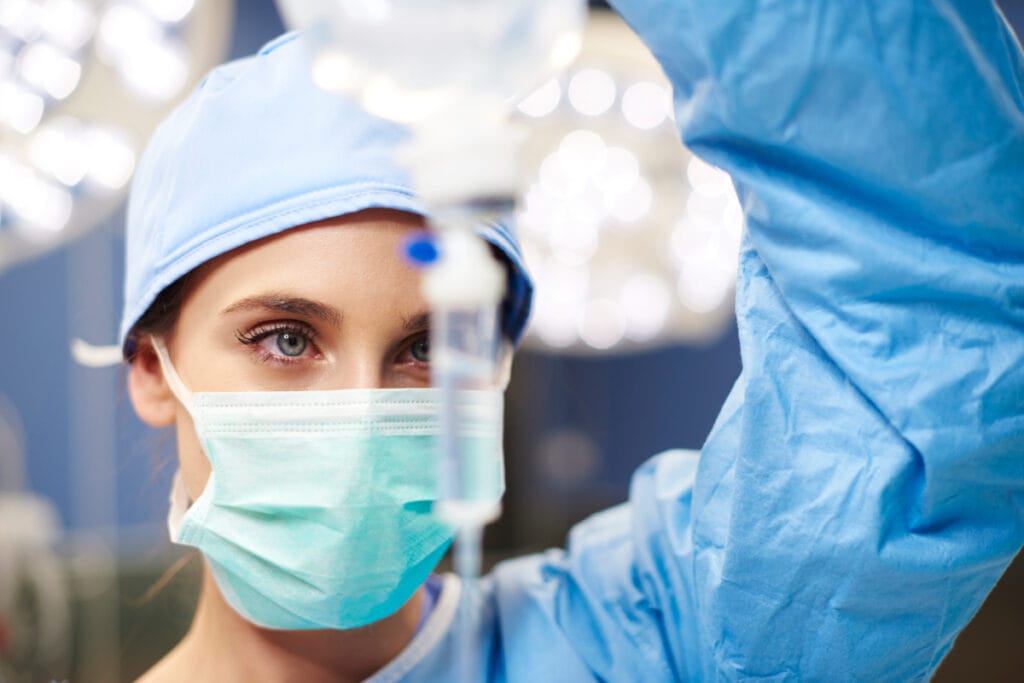 Female anesthesiologist administering an IV drip